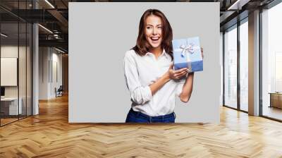 Beautiful happy woman holding gift box. Birthday or Valentine`s day celebrating concept Wall mural